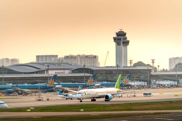 黃昏下的胡志明市新山一國際機場，越航機隊停靠航廈、塔台矗立其後
